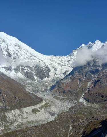 Majestic snow-capped mountain peaks under a clear sky.