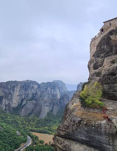 Monastery atop tall rock formations.