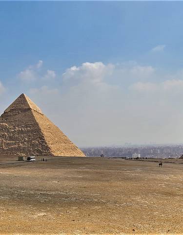 Panoramic view of the Pyramids of Giza under clear sky.