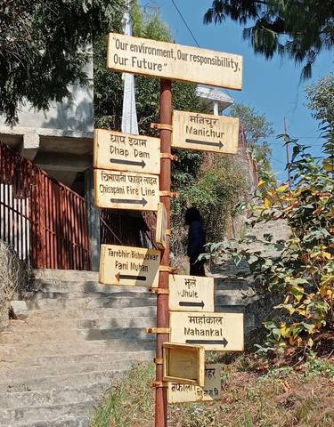 Close-up of a signpost with various destination names.