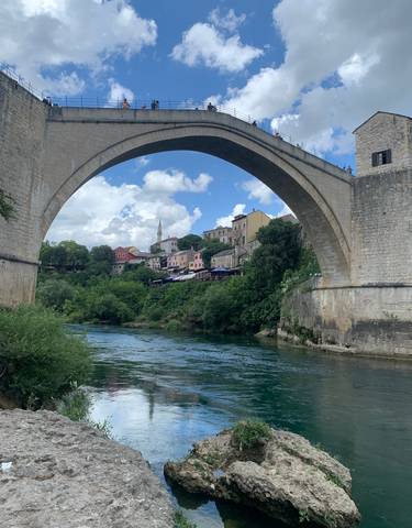 Stari Most bridge with a town view in the background.