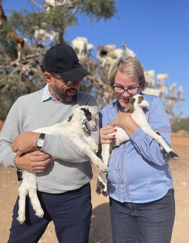 Couple holding baby goats