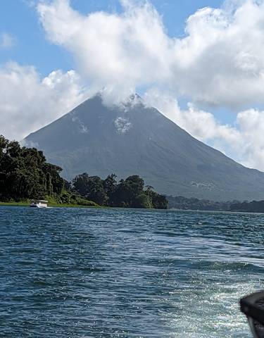 Scenic view of a lake with a volcano in the distance.