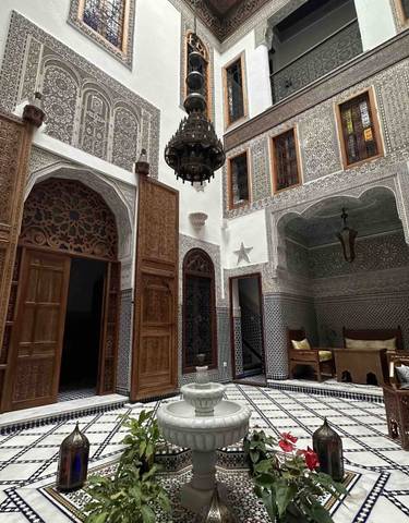 Intricate indoor architecture with mosaics and archways.