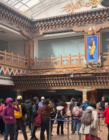 Decorative building interior with people standing in line.