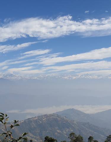 Expansive mountain range under a blue sky.