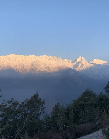 Snow-capped mountain range with a clear blue sky.