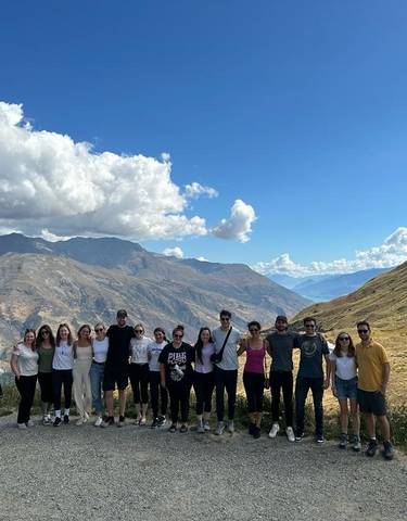 Group of people posing with mountains