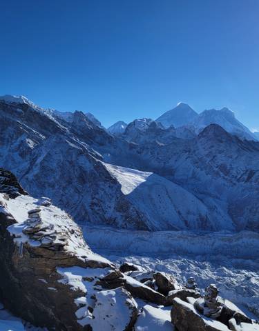 Snow-covered mountains and glacier under a clear sky.