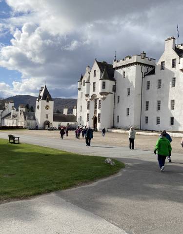 White castle with tourists walking around.