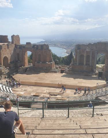 Ancient ruins with a sea view in the background.