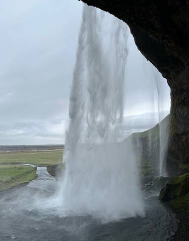 Waterfall cascading down with scenic horizon.