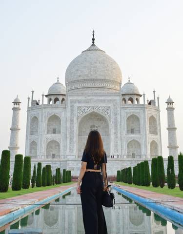 A person standing in front of the Taj Mahal
