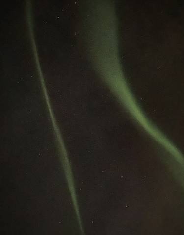 The Northern Lights streaking across a starry night sky