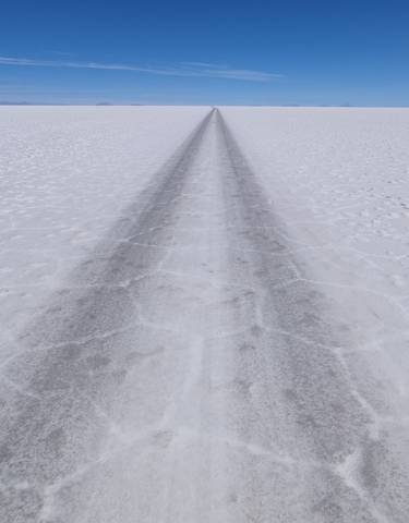 Long perspective view of a track across a vast salt flat.