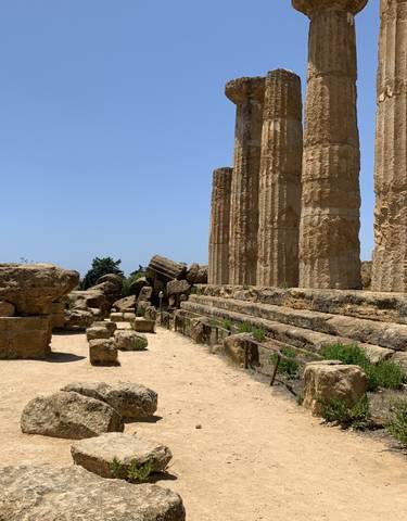 Ancient ruins with columns and a clear blue sky.