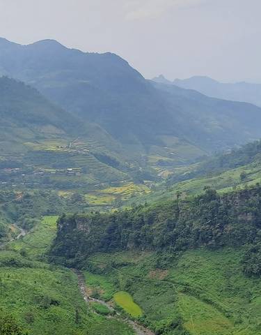 Panoramic view of a lush green mountain valley.
