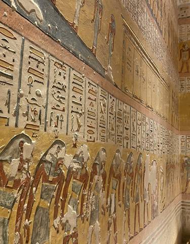 Intricately decorated ancient Egyptian wall with hieroglyphs.