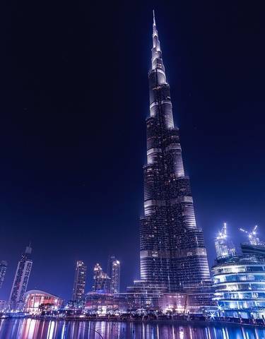 Nighttime view of a skyscraper and city lights.