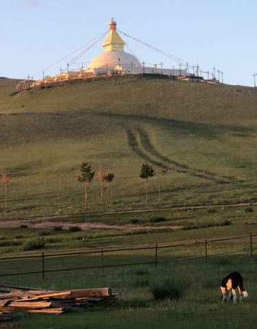 Hill with a structure at the top, tracks leading up.