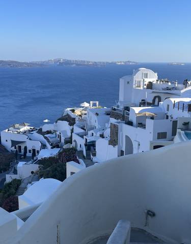 White-washed buildings on cliffs overlooking the Aegean Sea.