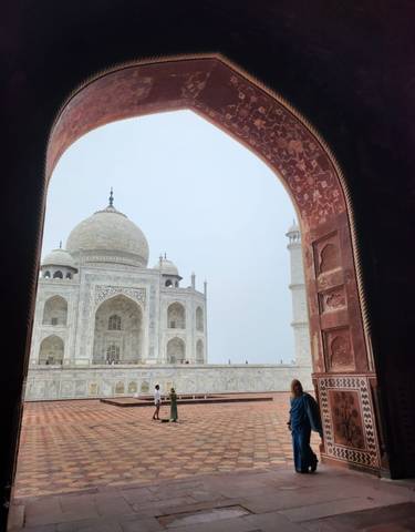 The Taj Mahal framed by an ornate archway.