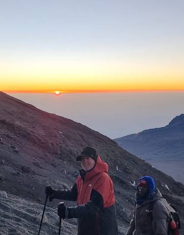 Hikers enjoying a sunrise view from a mountain.