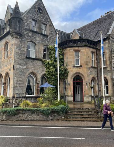 Historic stone building with arched windows.
