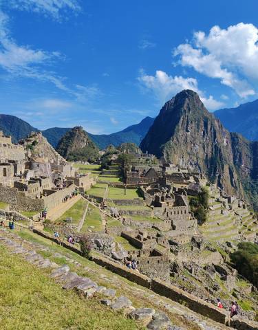Machu Picchu ruins with mountain backdrop.