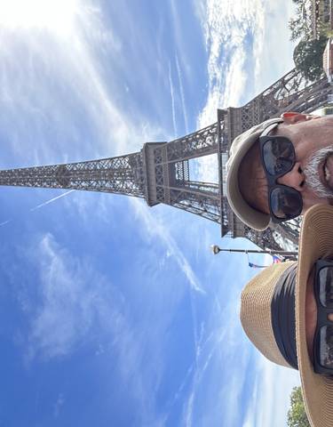 Tourists posing near the Eiffel Tower.