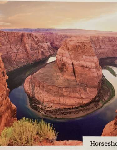 Aerial view of a meandering river in a canyon.