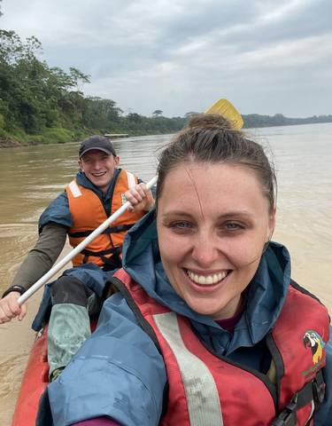 Two people canoeing in a river.