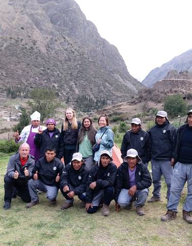 Group of hikers posing in a mountainous valley.
