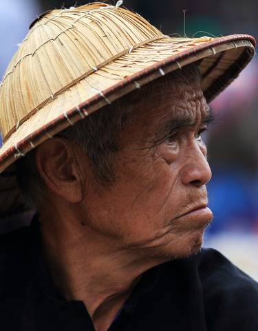 Portrait of a man in traditional hat looking sideways.
