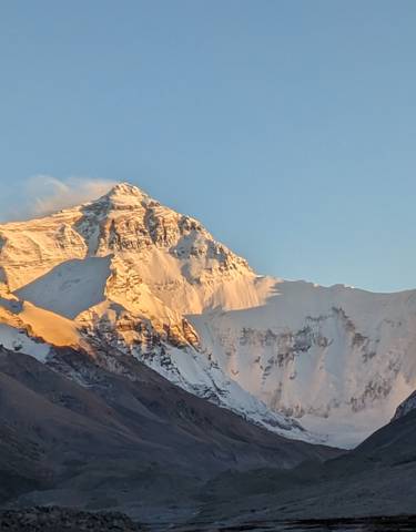 Snowcapped mountain peaks at sunrise or sunset.