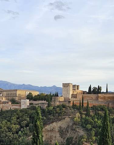 Alhambra palace complex with mountains in the background.