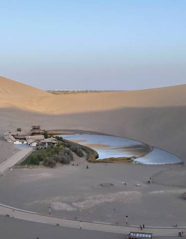 Crescent Lake oasis surrounded by sand dunes.
