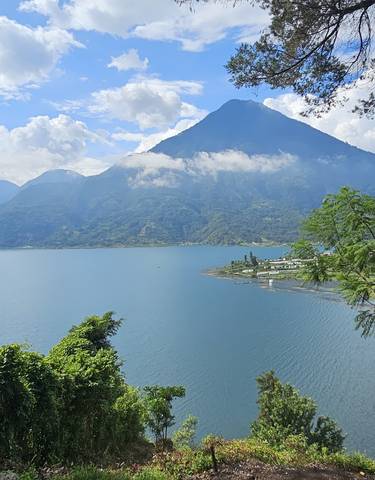 View of a volcanic lake surrounded by greenery.