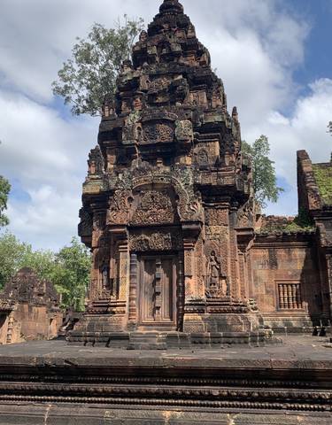 Banteay Srei, a richly decorated temple with detailed stone carvings.