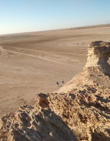 Desert landscape with rocky formation.
