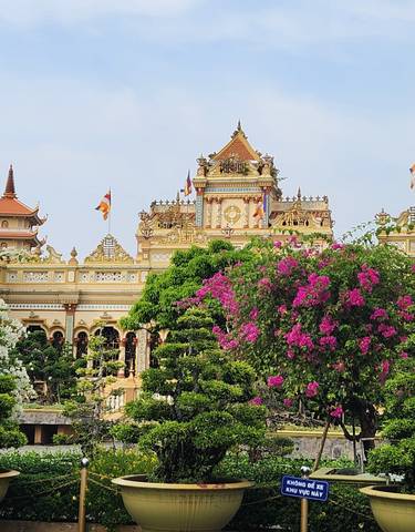 Colorful temple surrounded by lush gardens.