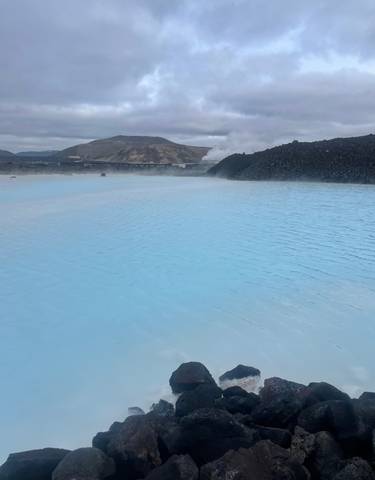 Blue lagoon with geothermal steam rising.
