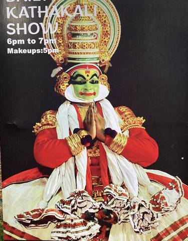 Traditional Kathakali performer in vibrant costume and makeup.