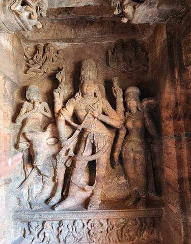 Ancient rock carvings depicting deities and figures.