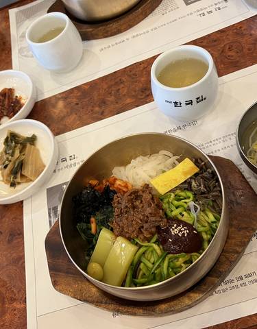 Traditional Korean meal served in bowls on a table.