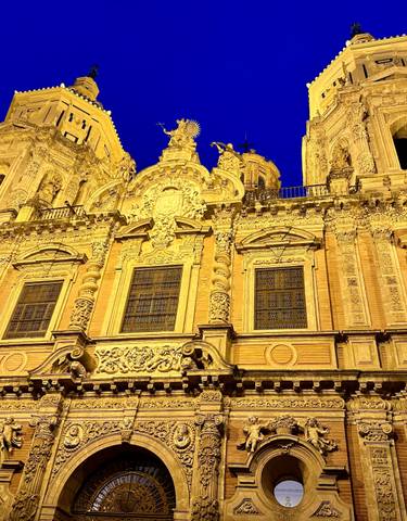 A beautifully illuminated cathedral at night with intricate details.