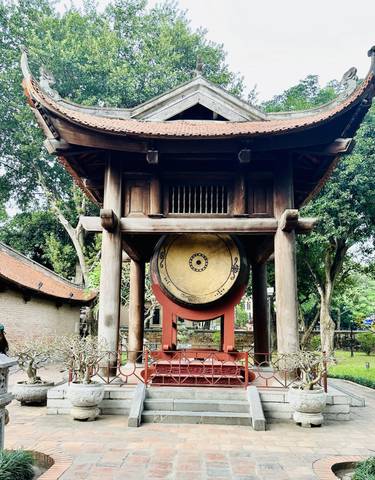 Large drum housed within an ancient wooden temple structure.