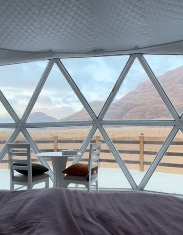 View from inside a dome accommodation with a mountain view.