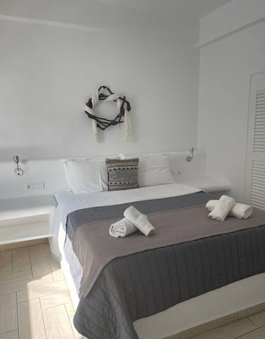 Minimalistic hotel room with neatly arranged towels.