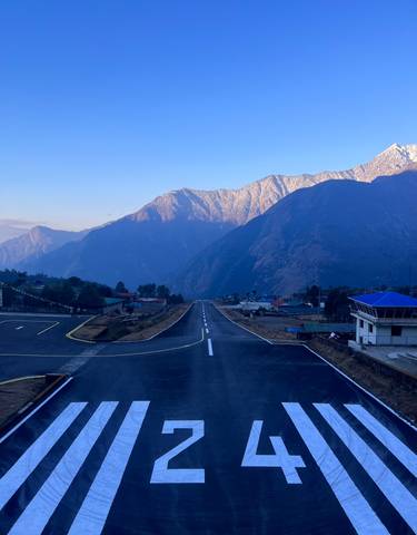 Runway surrounded by mountains.